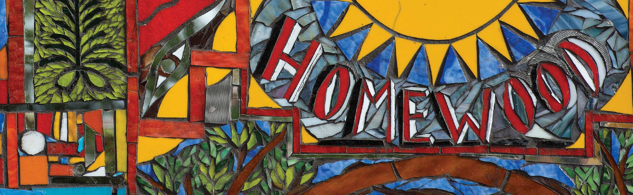 a portion of a colorful stained glass artwork at the building where the community engagement center in homewood is located.