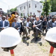 the new granada groundbreaking ceremony; hard hats and shovels are in the foreground with the audience seated in the background